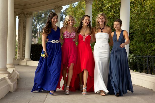 A group of teens wearing a selection of our prom dresses